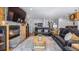 Open living area with stone fireplace, wood accents, comfortable seating, and staircase at 12117 Cypress Ln, Clermont, FL 34711