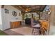 Well-equipped outdoor kitchen boasts a wooden countertop bar, sink, and grill, perfect for entertaining guests at 12117 Cypress Ln, Clermont, FL 34711
