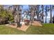 Charming outdoor space with a hot tub, fire pit, and lounge chairs, providing an ideal spot for relaxation at 12117 Cypress Ln, Clermont, FL 34711