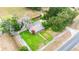 Aerial view of a home with a lush green yard and mature trees at 132 E Belt Ave, Bushnell, FL 33513