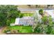 Aerial view of a home on a lush lot with a well-maintained lawn and mature trees at 132 E Belt Ave, Bushnell, FL 33513