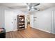 Bedroom featuring wood floors, ceiling fan, and a bookcase at 132 E Belt Ave, Bushnell, FL 33513