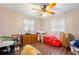 Neutral bedroom with a wood floor, natural light and ceiling fan at 132 E Belt Ave, Bushnell, FL 33513