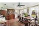 Bright dining room with large windows and wooden furniture at 132 E Belt Ave, Bushnell, FL 33513