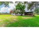 One-story home featuring a large yard and covered area at 132 E Belt Ave, Bushnell, FL 33513