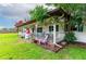 Inviting front porch with white railing, colorful decor, and a cozy seating area at 132 E Belt Ave, Bushnell, FL 33513