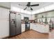 Bright kitchen featuring stainless steel appliances and white cabinets at 132 E Belt Ave, Bushnell, FL 33513