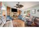 Cozy living room featuring a stone fireplace and comfortable seating at 132 E Belt Ave, Bushnell, FL 33513