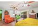 View of a cozy living room with wood floors, ceiling fans, and sliders to the lanai at 132 E Belt Ave, Bushnell, FL 33513