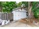 Outbuilding structure featuring double doors and a mature tree at 132 E Belt Ave, Bushnell, FL 33513