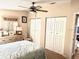 Bedroom featuring a bed with patterned quilt, lamps and dresser with mirror at 1336 E Schwartz Blvd, The Villages, FL 32159