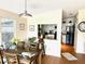 Open dining room showcasing a large window, view to the kitchen, and dining table at 1336 E Schwartz Blvd, The Villages, FL 32159