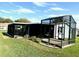 A beautiful angle of the screened-in patio and side yard of the home at 1336 E Schwartz Blvd, The Villages, FL 32159