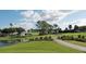 Picturesque golf course view with manicured greens, pond, and a walking path at 1336 E Schwartz Blvd, The Villages, FL 32159