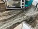 Close up shot of the kitchen counter showing a speckled gray and brown tone at 1336 E Schwartz Blvd, The Villages, FL 32159