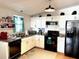 Well-lit kitchen featuring modern appliances and ample counter space with white cabinets at 1336 E Schwartz Blvd, The Villages, FL 32159