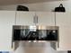 Modern stainless steel microwave above the range with white cabinets at 1336 E Schwartz Blvd, The Villages, FL 32159