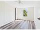 Neutral bedroom features wood-style flooring, a ceiling fan, and a view of the outdoors from the bright window at 13877 County Road 109F, Lady Lake, FL 32159