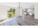 Bright dining area with modern flooring, chandelier, and view to the kitchen and backyard at 13877 County Road 109F, Lady Lake, FL 32159