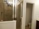 A spacious shower stall with glass doors and tiled walls at 1408 Diamond Loop Dr, Kissimmee, FL 34744