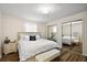 Bright bedroom featuring wood floors, large bed, and mirrored closet at 151 Shiloh Ave, Lady Lake, FL 32159