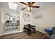 Bright dining area with wood flooring, ceiling fan, and view of adjacent kitchen with breakfast bar at 151 Shiloh Ave, Lady Lake, FL 32159