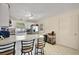 Well-lit kitchen with a breakfast bar, white cabinetry, stainless steel appliances, and tile flooring at 151 Shiloh Ave, Lady Lake, FL 32159