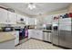 Functional kitchen featuring stainless steel appliances, white cabinetry, and tile flooring at 151 Shiloh Ave, Lady Lake, FL 32159