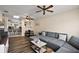 Inviting living room with hardwood floors, ceiling fans, skylight, and comfortable gray sectional sofa at 151 Shiloh Ave, Lady Lake, FL 32159