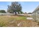 Spacious backyard featuring a storage shed, mature tree and a full privacy fence at 15318 Margaux Dr, Clermont, FL 34714