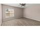 Neutral bedroom featuring a ceiling fan and wood-look tile floors at 15318 Margaux Dr, Clermont, FL 34714