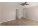 Neutral bedroom with a ceiling fan and wood-look tile floors at 15318 Margaux Dr, Clermont, FL 34714