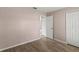 Simple bedroom featuring plank flooring, a closet, and neutral wall color at 15318 Margaux Dr, Clermont, FL 34714