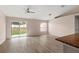 Bright living room featuring sliding glass doors leading to the backyard and wood flooring at 15318 Margaux Dr, Clermont, FL 34714