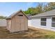 Exterior view of the storage shed, adjacent to the house and full privacy fence at 15318 Margaux Dr, Clermont, FL 34714