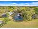 Aerial view of the home shows the screened pool, large backyard, and lush landscaping at 16839 Rockwell Heights Ln, Clermont, FL 34711