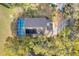 An aerial view shows a screened pool with a lounge area, complemented by mature landscaping at 16839 Rockwell Heights Ln, Clermont, FL 34711