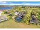 Stunning aerial view of a home featuring a screened pool and lush landscaping near a tranquil lake at 16839 Rockwell Heights Ln, Clermont, FL 34711