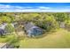 Aerial view of the home shows the expansive backyard, screened pool, and surrounding trees at 16839 Rockwell Heights Ln, Clermont, FL 34711