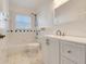 Well-maintained bathroom featuring a bathtub, toilet, and a vanity with ample countertop space at 16839 Rockwell Heights Ln, Clermont, FL 34711