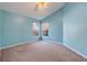 Serene blue bedroom featuring two windows providing natural light and a cozy atmosphere at 16839 Rockwell Heights Ln, Clermont, FL 34711