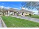 Charming clubhouse entrance featuring stone accents, manicured landscaping, and a welcoming driveway at 16839 Rockwell Heights Ln, Clermont, FL 34711