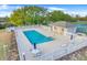 Community pool area with seating, fencing, and a service building, creating an inviting recreational space at 16839 Rockwell Heights Ln, Clermont, FL 34711