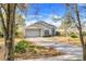 Well-maintained single-story home with a lush front lawn and a driveway leading to a two-car garage at 16839 Rockwell Heights Ln, Clermont, FL 34711