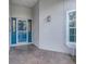 A tiled entryway leading to a blue front door with sidelights and a transom window at 16839 Rockwell Heights Ln, Clermont, FL 34711