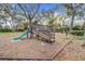 A safe, fun community playground provides recreation with a slide and swing set surrounded by shade trees at 16839 Rockwell Heights Ln, Clermont, FL 34711