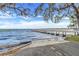 Waterfront with concrete boat ramp and fishing pier on a windy day at 16839 Rockwell Heights Ln, Clermont, FL 34711