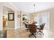 This dining area has tile flooring and a glass table with seating for four and kitchen access at 17126 Se 78Th Larchmont Ct, The Villages, FL 32162