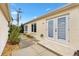 Exterior of the home with double glass doors, featuring a landscaped walkway and a well-maintained yard at 17126 Se 78Th Larchmont Ct, The Villages, FL 32162