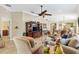 Comfortable living room featuring neutral tones, tile flooring, comfortable seating, and an entertainment center at 17126 Se 78Th Larchmont Ct, The Villages, FL 32162